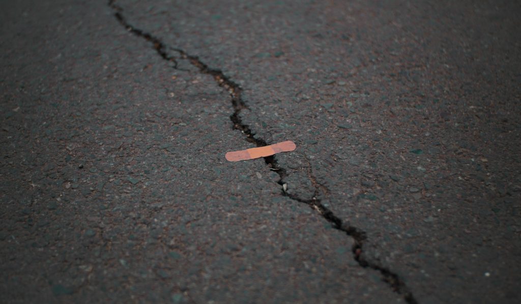 crack in the pavement covered with a plaster