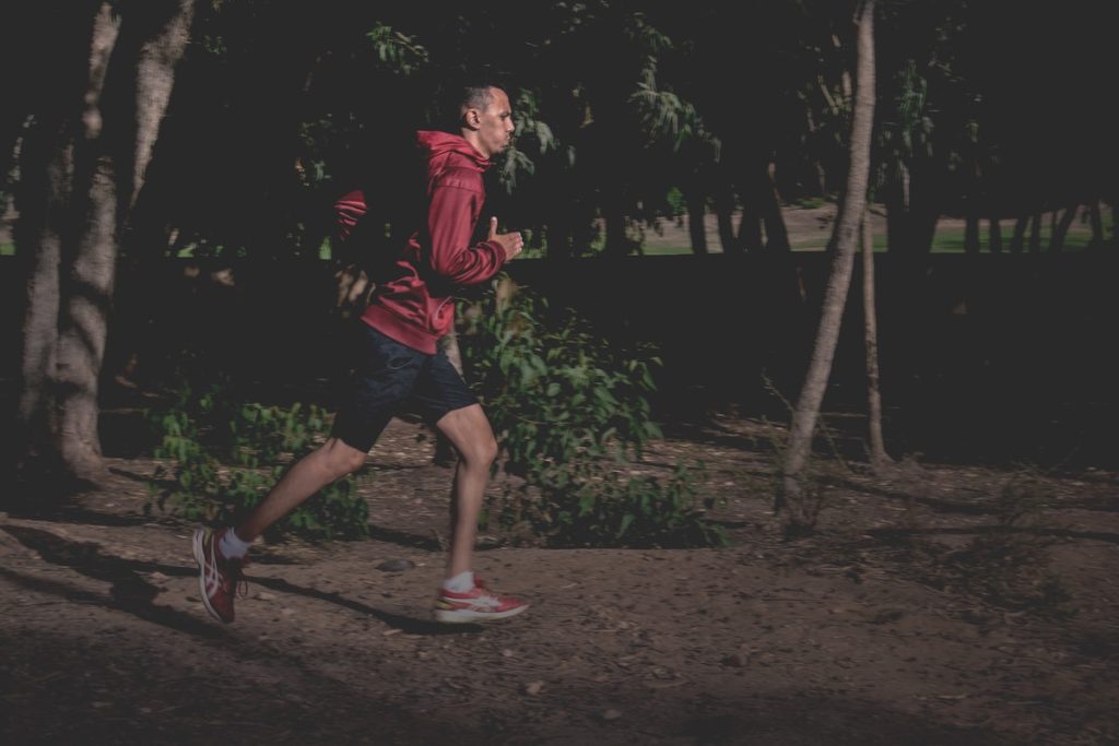 Man working out late evening running in the dark