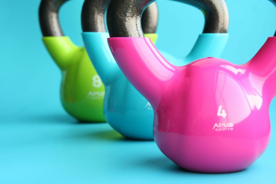 Three kettlebell, green, blue and pink
