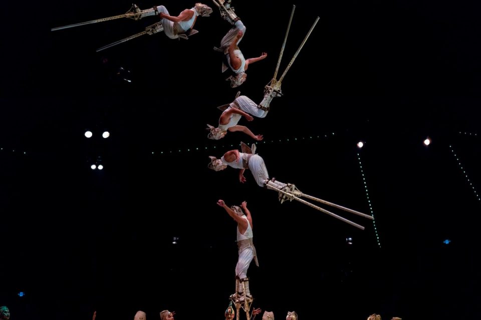 performance not perfection acrobats jumping on stilts