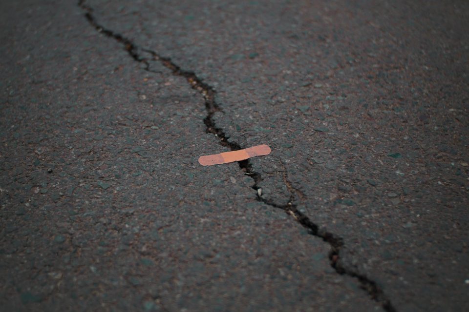crack in the pavement covered with a plaster